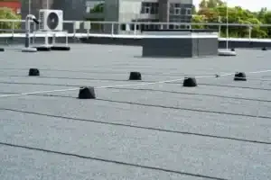 Modified bitumen sheets lapped across a flat roof deck.